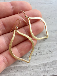 Brushed Tulip Earrings, gold, in hand